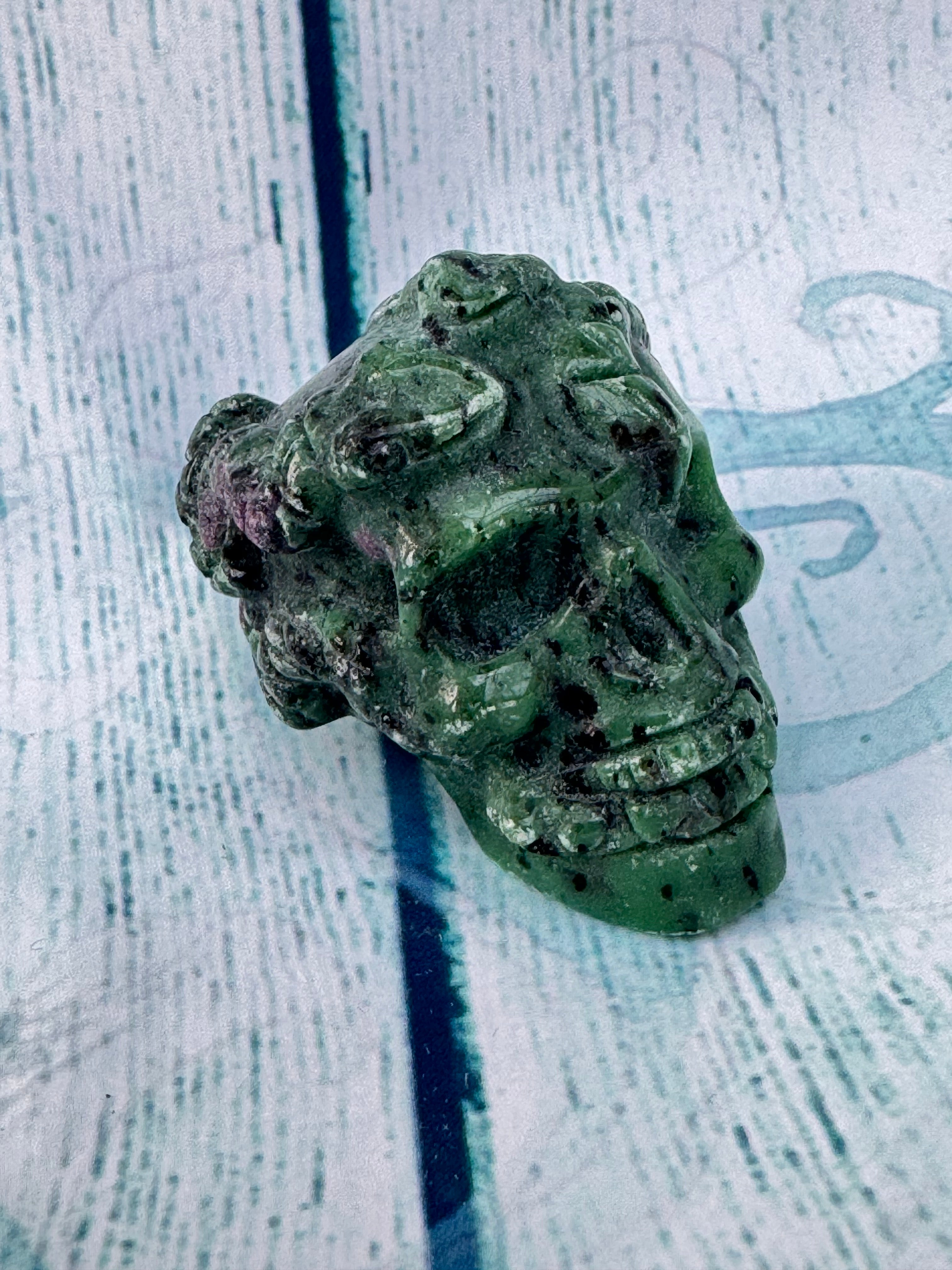 Ruby in zoisite carved crystal skull